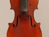 an old violin with a bow hanging from it ' s back