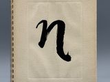 a white book with a black letter n on it