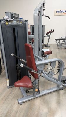 a gym room with machines and other equipment in it
