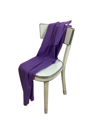 purple blanket draped over a chair on a white background