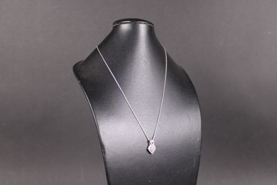un gros plan d'un collier porté par un mannequin sur fond noir