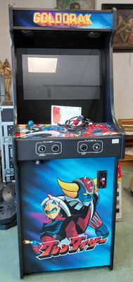 une console de jeux vidéo installée dans une pièce où se trouvent d'autres jeux vidéo