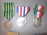 three medals and a medal on a table next to a coin