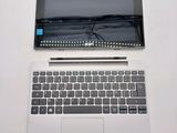 a laptop computer sitting on top of a white table