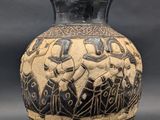 a black and white vase with a picture of people on it