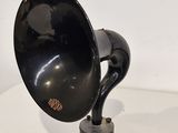an old black phonom on a white table with a white background