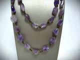 necklace made of amethorate and gold beads on a mannequin