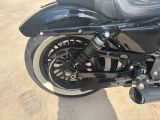 a close up of a motorcycle parked in a parking lot