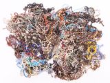 a pile of assorted beads on a white surface