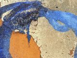 a blue and orange painting on the sidewalk of a building