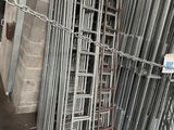a large pile of metal pipes in a warehouse