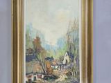 an oil painting of a farm scene in a gold frame on a blue wall