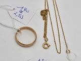 two gold rings and a gold chain with a price tag on it
