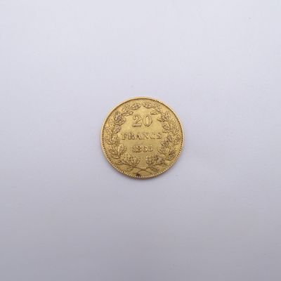 gros plan d'une pièce d'or sur une surface blanche
