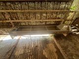 a wooden bench in the middle of a dirty room