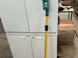 a picture of a white refrigerator in a warehouse with a handle on it