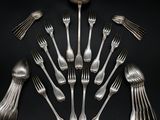 a lot of forks and spoons arranged in a circle