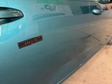 a blue car that has a sticker on the side of it