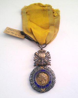 medals are displayed on a white surface with a yellow ribbon
