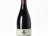 a close up of a bottle of wine on a white surface