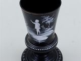 a black vase with a picture of a boy on it