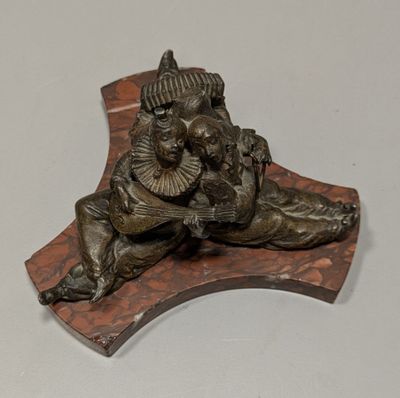a bronze statue of a man and a dog on a wooden plaque