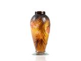 a glass vase with a design on it on a white surface