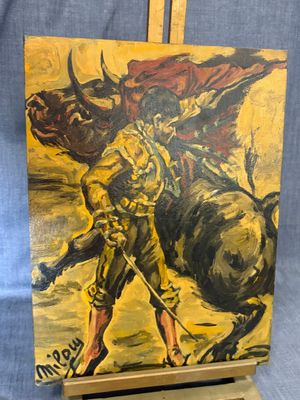 painting of a man riding a bull on a wooden easel
