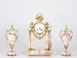 three different types of clocks and vases sitting on a table