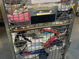 a metal cart with a lot of clothes in it