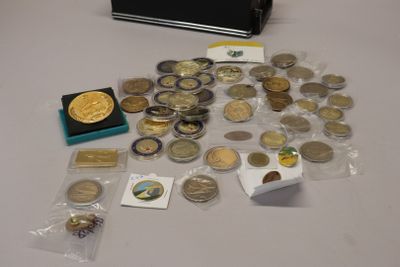 a suitcase full of coins and other items sitting on a table