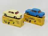 two toy cars are sitting on top of boxes on a white surface