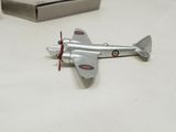 a toy airplane sitting on a table next to a box
