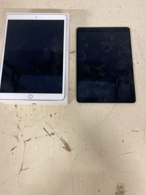 two ipads sitting next to each other on top of a table