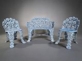 three chairs and a table in a room