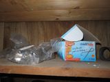 a box of toilet paper and a pair of scissors on a shelf