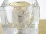 a small glass vase with a yellow object inside of it