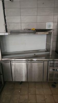a stainless steel kitchen with a sink and a dishwasher