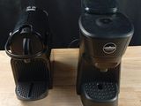 two coffee machines sitting on a table next to each other