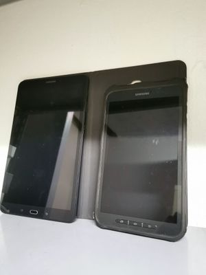two cell phones sitting side by side on a table