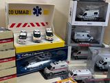 many different models of ambulances in boxes on the table