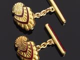 two pairs of gold cufflinks with red enamel and gold chain