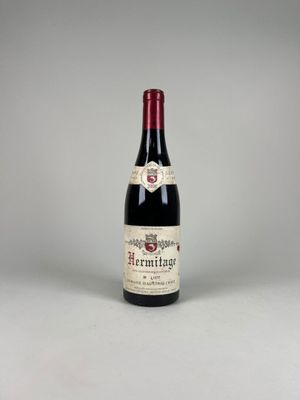 the bottle of red wine is sitting on the table