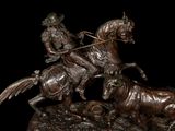 bronze statue of a man on a horse and a cow