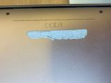 a hole in the back of a laptop that has been torn open