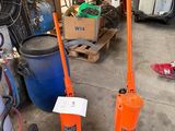 two orange jacks sitting next to each other in a garage