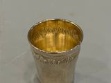 a silver cup that is sitting on a table