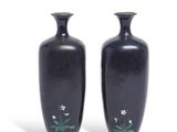two vases that are sitting side by side on a white surface