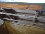 a wooden chest with a chain hanging from the top of it