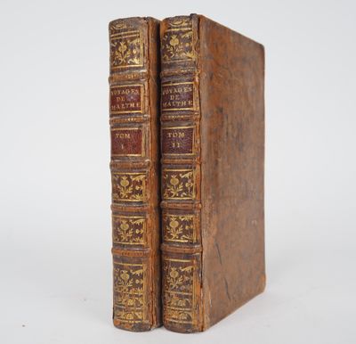 a pair of old books sitting on top of each other